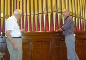 Dr. Marion Warpenberg (left) and board president Steve Ahrens take measurements in the sanctuary at Poseyville Christian.